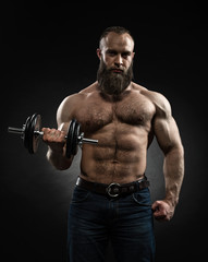 Fototapeta na wymiar Strong bearded bodybuilder with six pack, perfect abs, shoulders