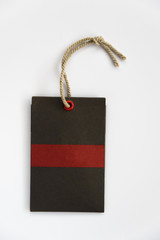 Blank label (tag) tied with stringon white background. Price tag