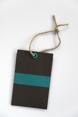 Blank label (tag) tied with stringon white background. Price tag