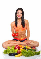 Portrait of slim fitness cherrful girl sitting in studio with se