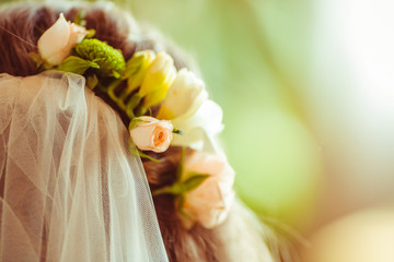 Pastel roses put in woman's hair