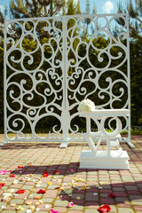 Lettering LOVE stands in the front of white wedding altar