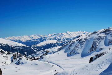 Snowy slopes in winter mountains. Skiing resorts
