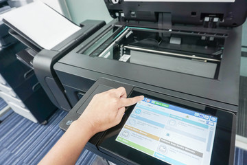 Businesswoman with printer touchscreen for scanning documents