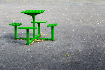 Green metal bench table set in a playground