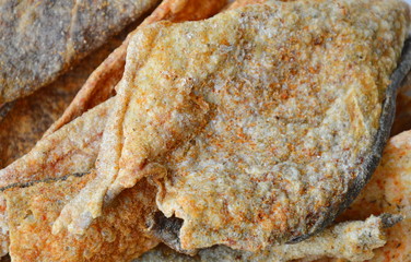 crispy fried fish skin with seasoning on dish