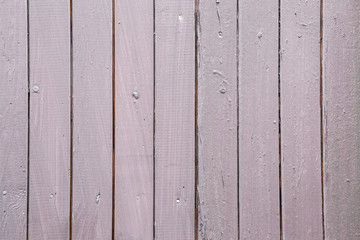 Wooden background with vertical lines and nails.