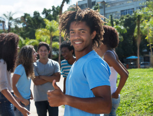 African american guy with amazing hairstyle and friends showing