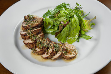 Dish juicy pork fillet cut into pieces round watered from above