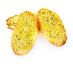 Garlic and herb bread slices on white background.