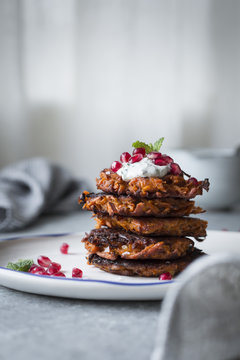 Harissa sweet potato latkes with spiced yogurt, mint and pomegra