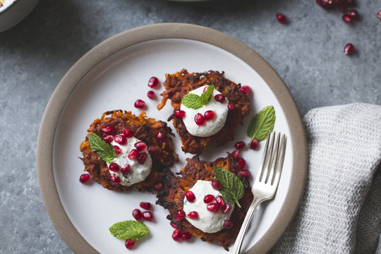Harissa sweet potato latkes with spiced yogurt, mint and pomegra