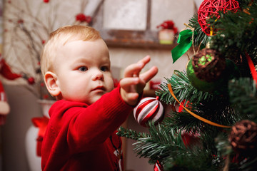 Funny baby decorate the Christmas tree