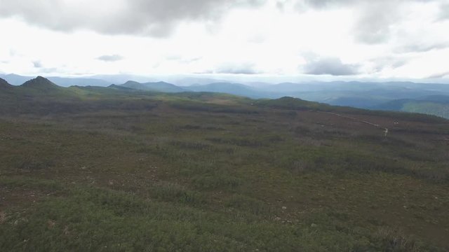 Slow rise above ground revealing beautiful mountainous landscape at Hartz Mountains National Park, Tasmania, Australia