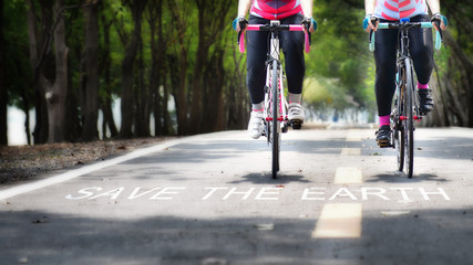 Fototapeta na wymiar Bike lane and words of save the earth on road, earth day concept and energy saving idea