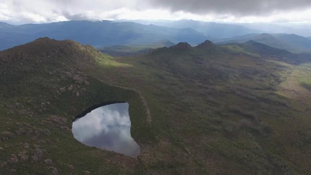 Backward flight away from Lake Perry at Hartz Mountains National Park, Tasmania, Australia