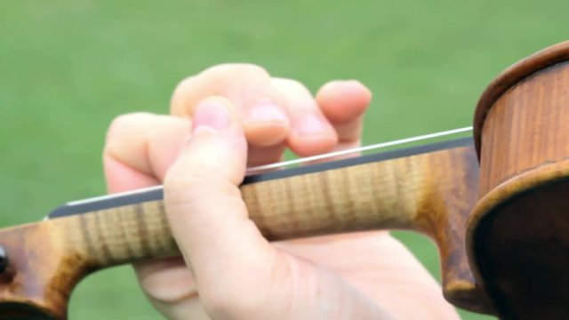 Aclose-up of a violin being played.