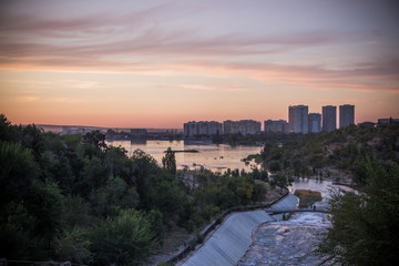 Fototapeta na wymiar Sayran lake - evening city view, Almaty, Kazakhstan
