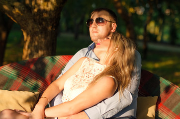 Young couple sitting on the garden bench