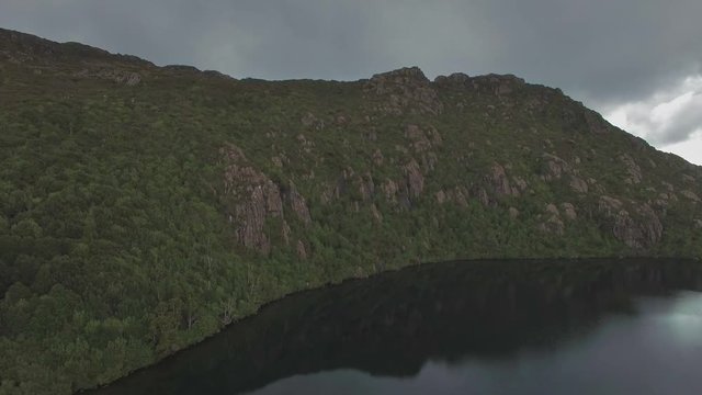 Slow rise above Lake Esperance and pan to reveal beautiful landscape of Hartz Mountains National Park, Tasmania, Australia