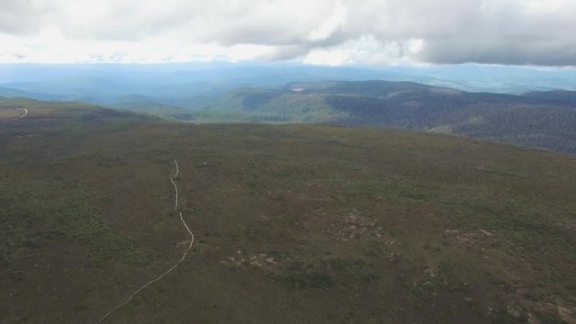 Forward flight above winding boardwalk walking trak at Hartz Mountains National Park, Tasmania, Australia