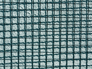 Metal grid and cyan cement wall texture.