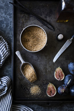 Brown sugar and figs on a baking tray. Ingredients for fig swirl