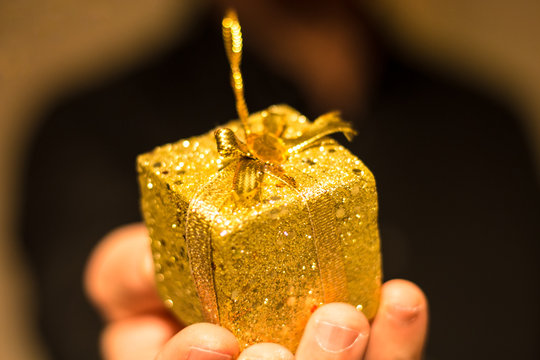 Man Giving Golden Gift
