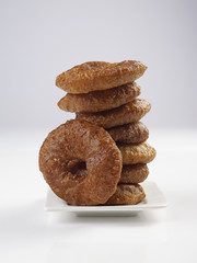 ADHIRASAM SERVED IN A WHITE PLATE ON WHITE BACKGROUND