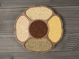 raw millet varieties kept in a wooden bowl