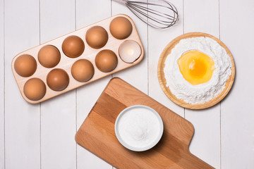Egg in flour. Making dough background. Baking with raw eggs, sug