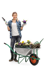 Female gardener holding flower and spade