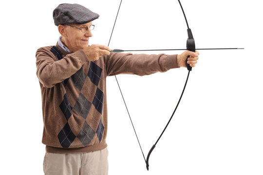 Elderly man aiming with a bow and arrow