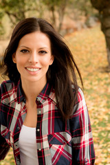 Fototapeta premium Beautiful brunette girl taking a walk in autumn