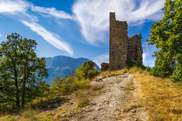 Fototapeta na wymiar Ruins of Saint-Firmin castle (14th century medieval construction) at the entrance of Valgaudemar valley in the Hautes-Alpes. Summer in the Southern French Alps. France