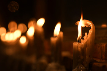 Candles light. Golden light of candle flame.