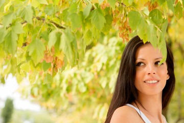 Beautiful brunette girl taking a walk in autumn