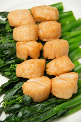   scallops and vegetables on white dish