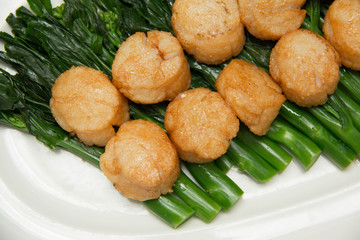   scallops and vegetables on white dish