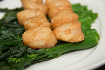   scallops and vegetables on white dish