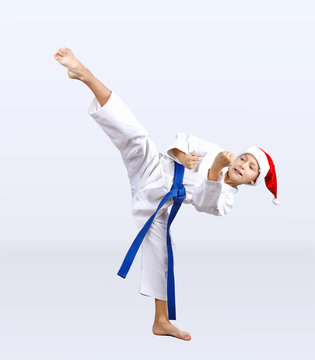 Karateka beats kick in the hat of Santa Claus