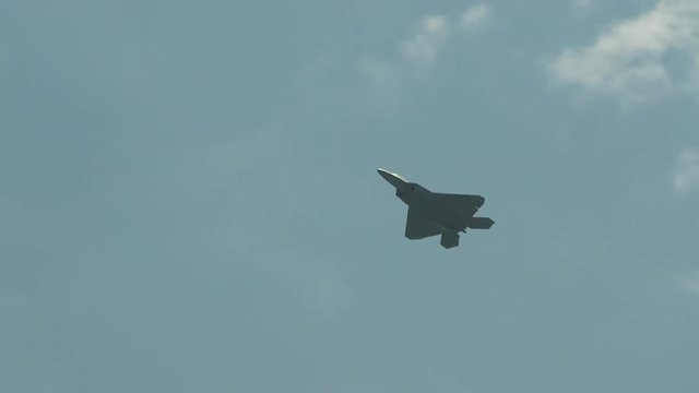 Tracking shot of F22 fighter jet flying in sky
