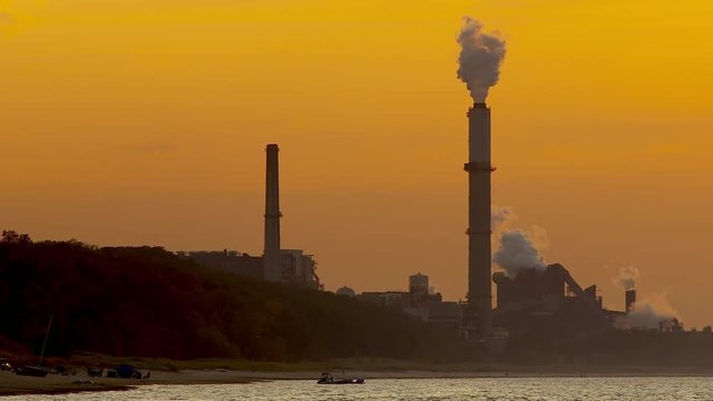 View of flue gas stack during sunset