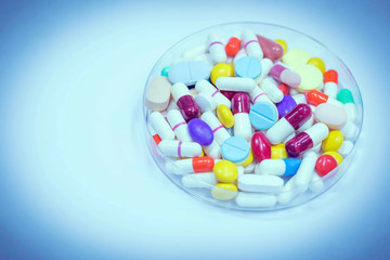 Variety of colorful medication in plate. Use for background.