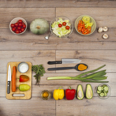 High Angle Still Life View of Knife and Wooden Cutting Board Surrounded by Fresh Herbs. Assortment...