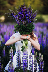 Bride hides her face behind a bouquet of lavanders