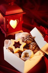 Open box of cookies beside red colored lamp