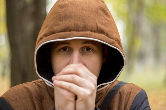 The Young Man Warming His Hands Outdoors