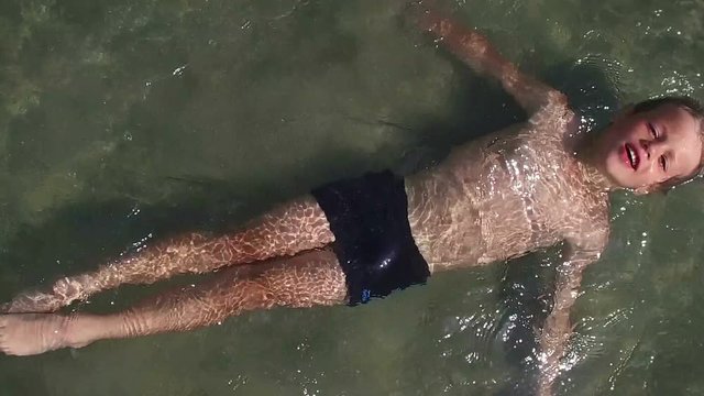 Little boy enjoing time in water, slow motion