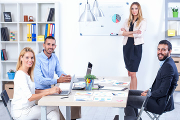 Group Of Business People Having Meeting In Office. Business partners discussing documents and ideas at meeting